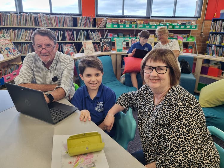 Student with grandparent in class celebrating grandparents day