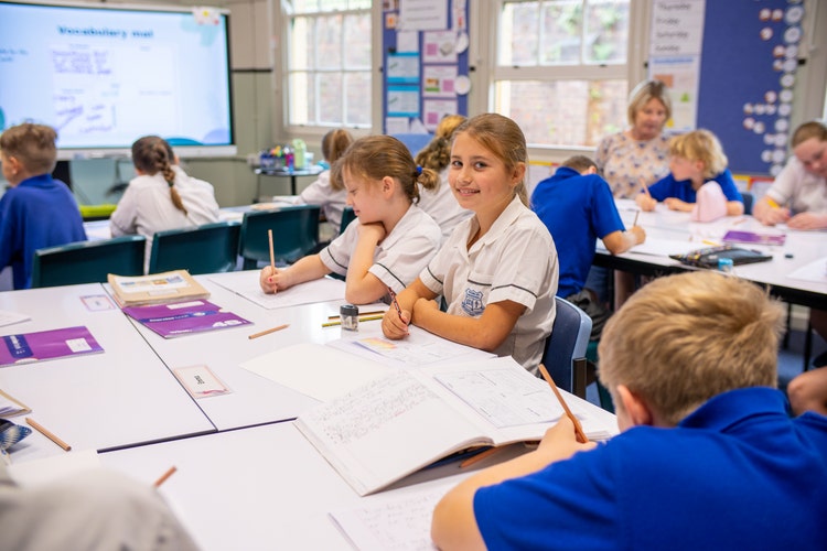 Student smiling and learning in class