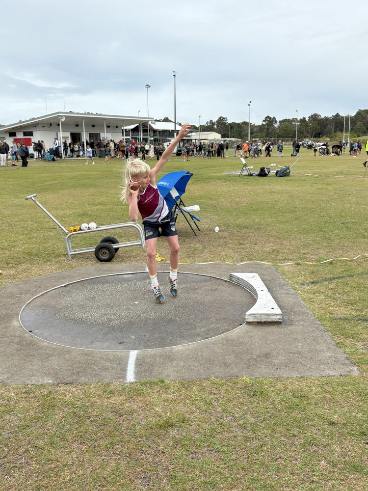 Student throwing a shot put at Athletics Carnival
