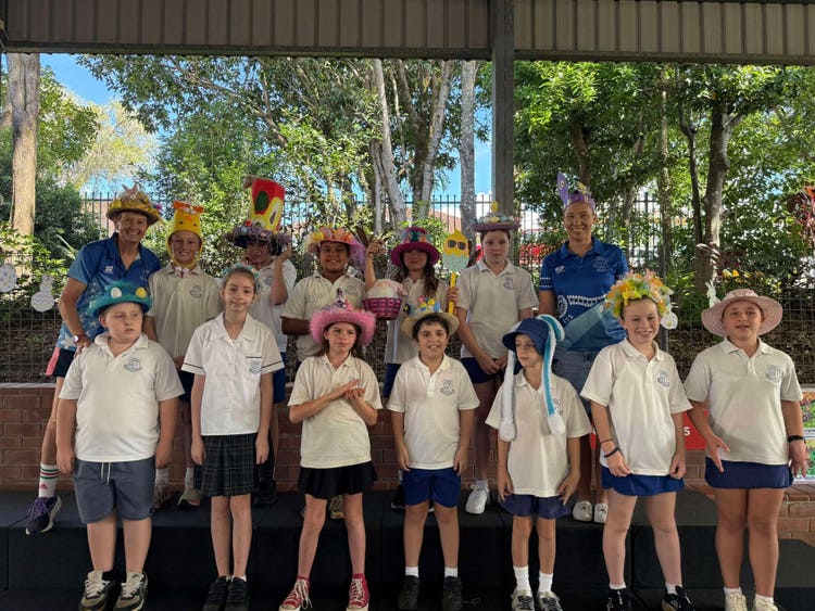 Students and teacher dressed up for easter hat parade