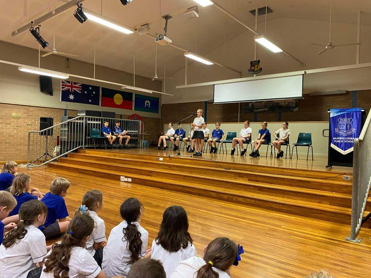 Student on stage doing speech for Public Speaking